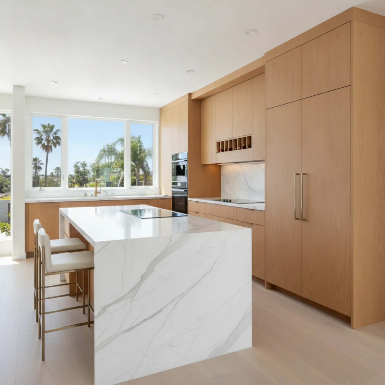 Bright renovated kitchen in San Diego County with white custom cabinets and quartz island